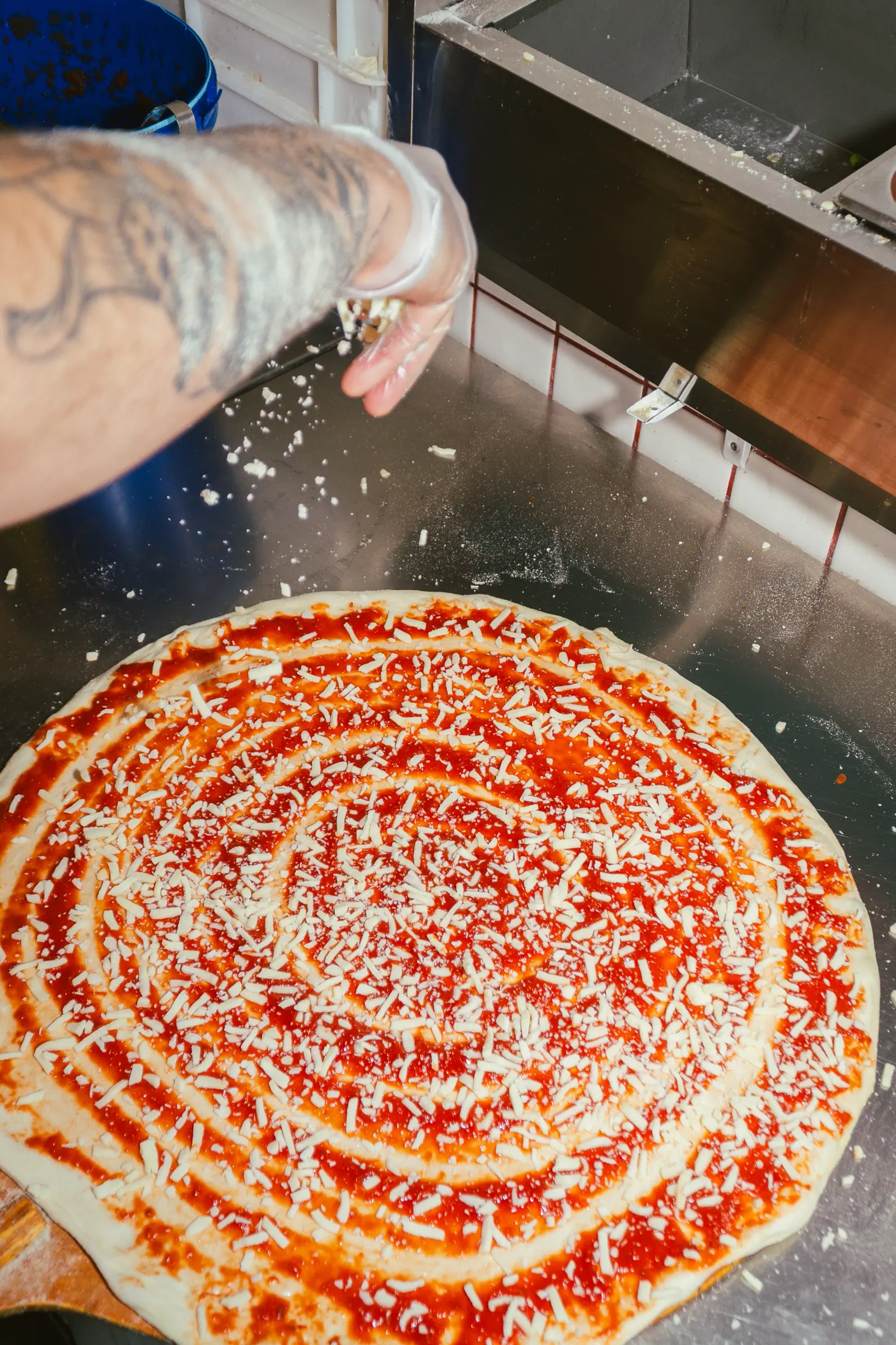 Spreading mozzarella on a New York pie at Frankie's