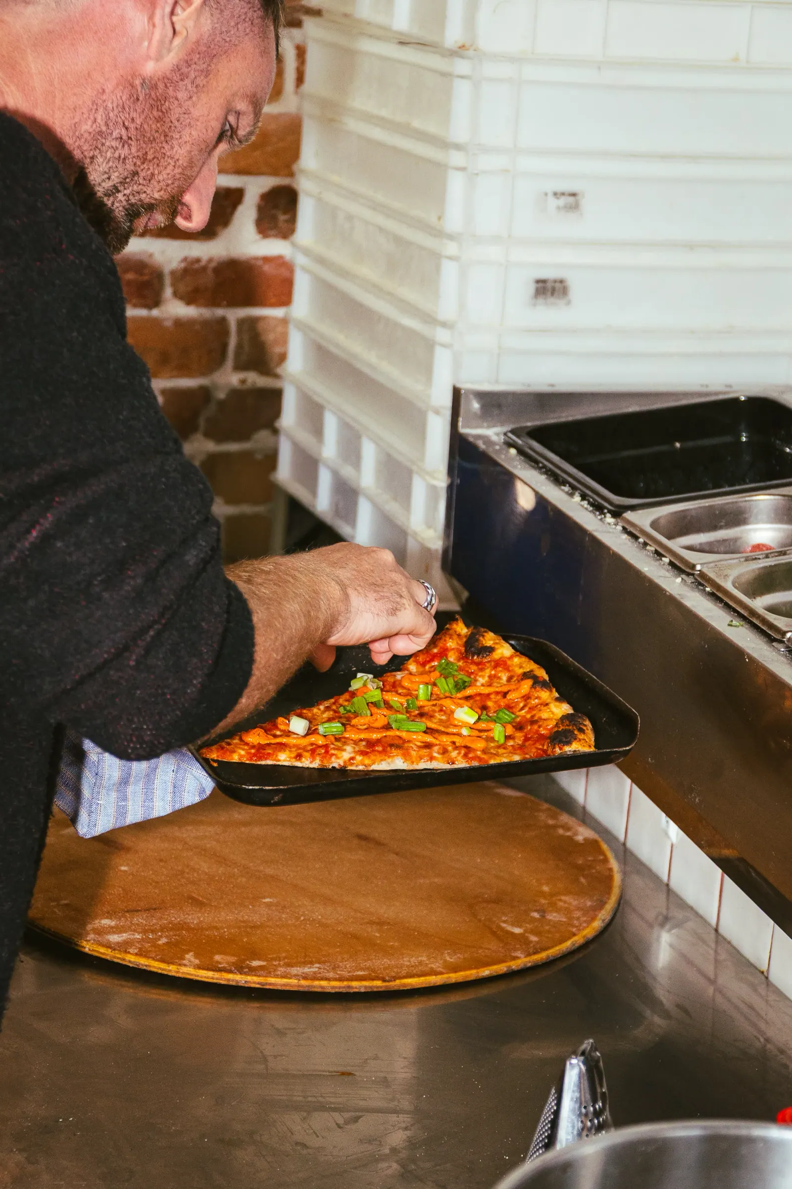 Hand-stretching New York pizza dough at Frankie's
