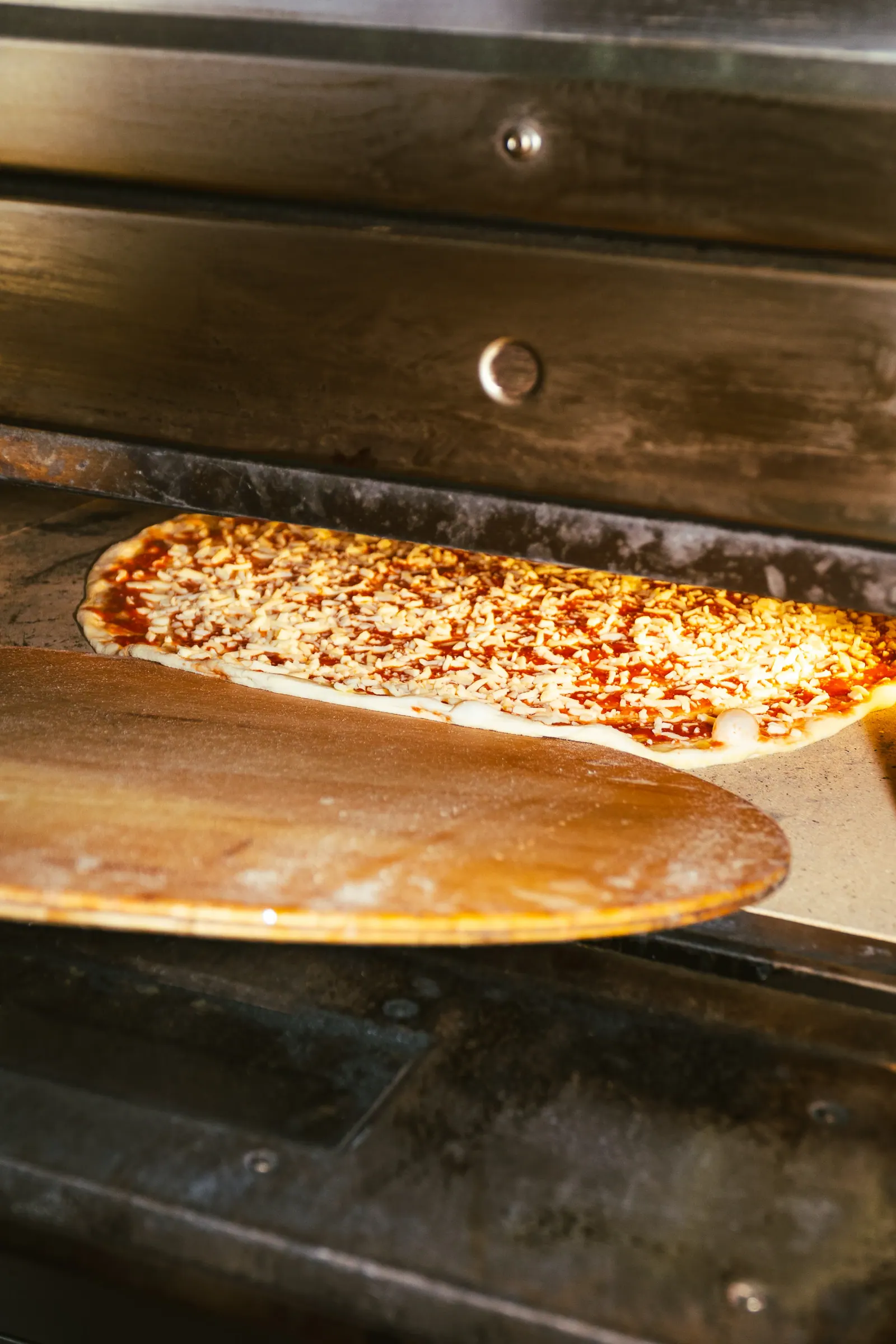 Placing pepperoni on a pizza at Frankie's Cork