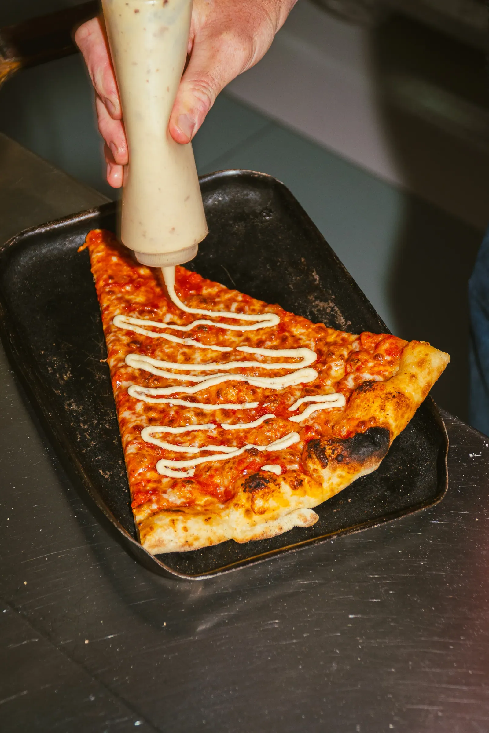 Serving a slice of pizza at Frankie's Slice Shop